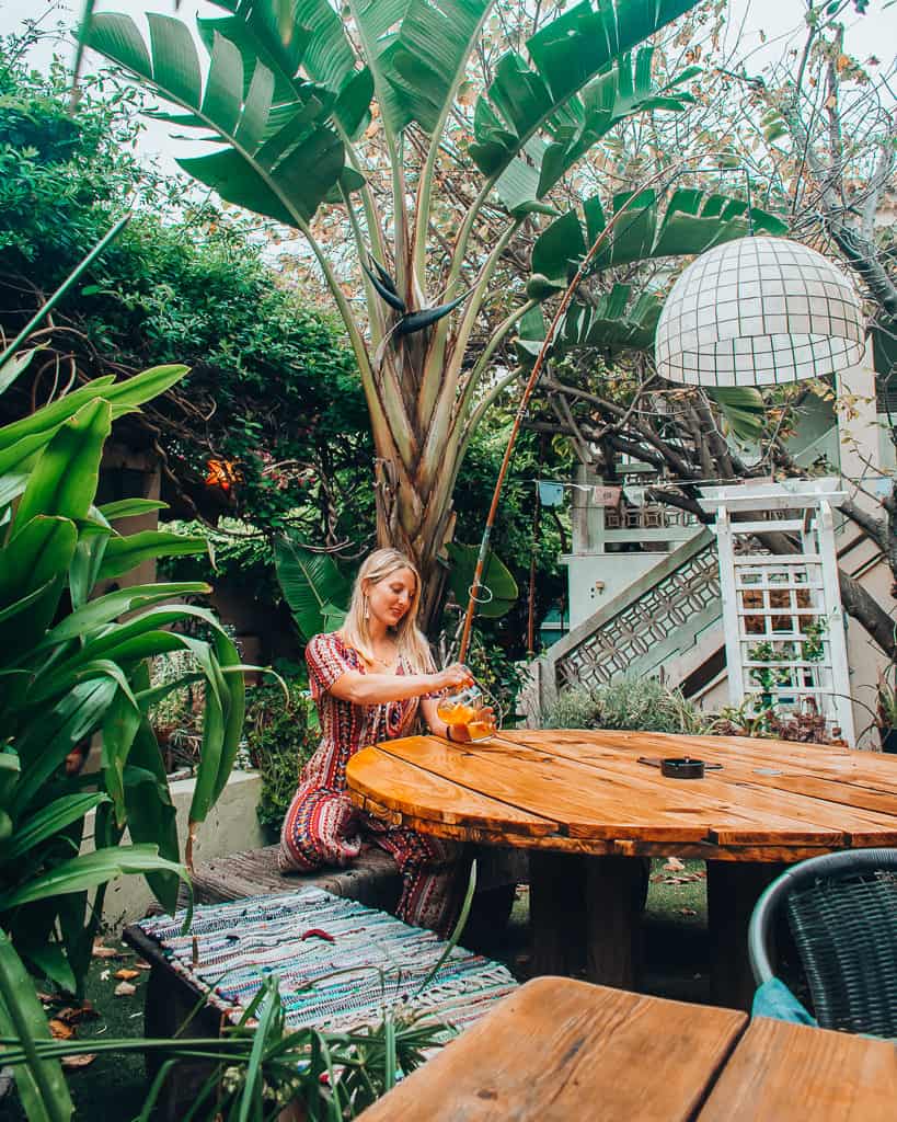 a girl sitting at a table drinking sangria