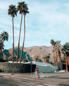 girl riding bike in front of mountains