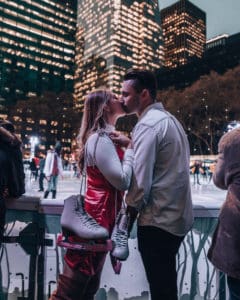 couple standing in front of ice skating rink