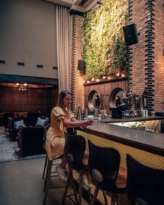 girl sitting at hotel bar