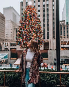 girl standing in front of ice rink