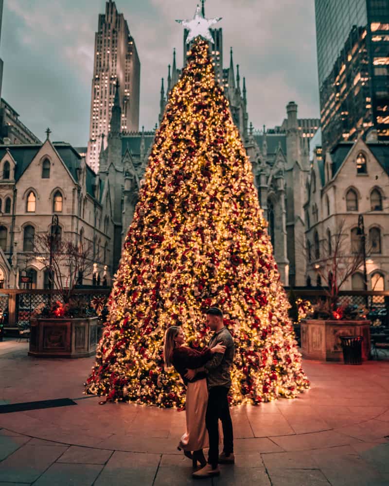 couple standing in front of Christmas tree