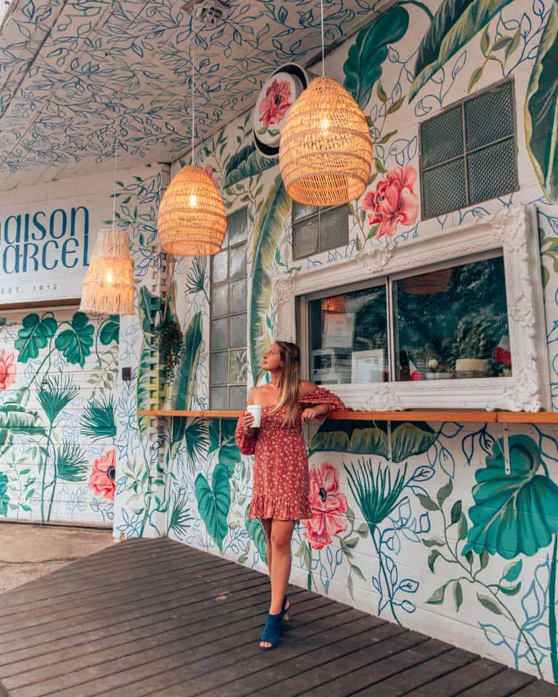 girl standing at to go window