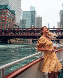 girl standing at side of boat