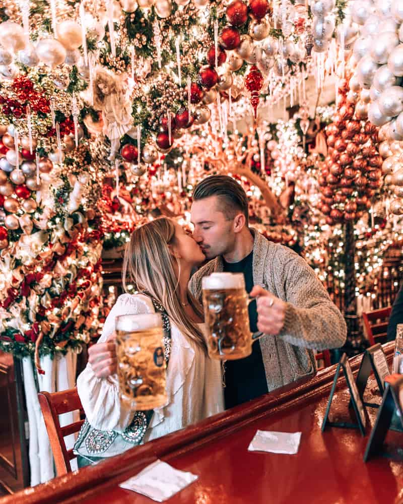 couple standing in restaurant with Christmas decor