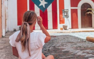 girl sitting on a street corner