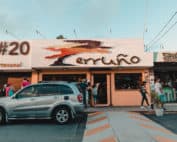 car in front of a restaurant store front