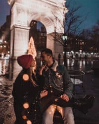 couple sitting on bench at city park