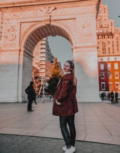 girl standing in front of arc